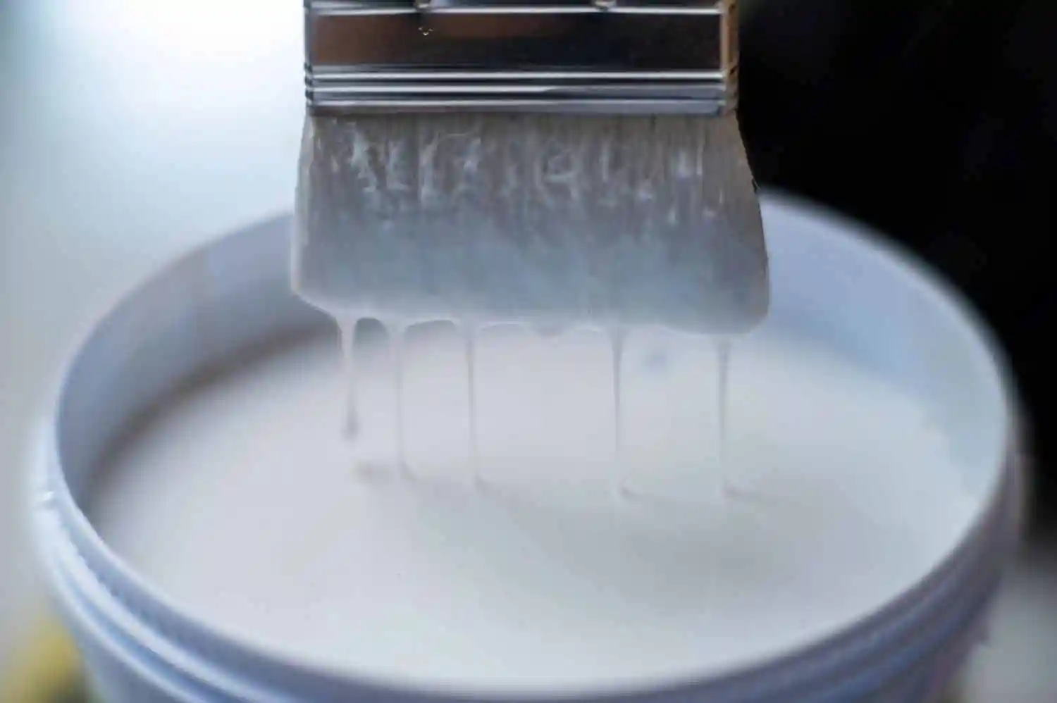 white paint container with brush